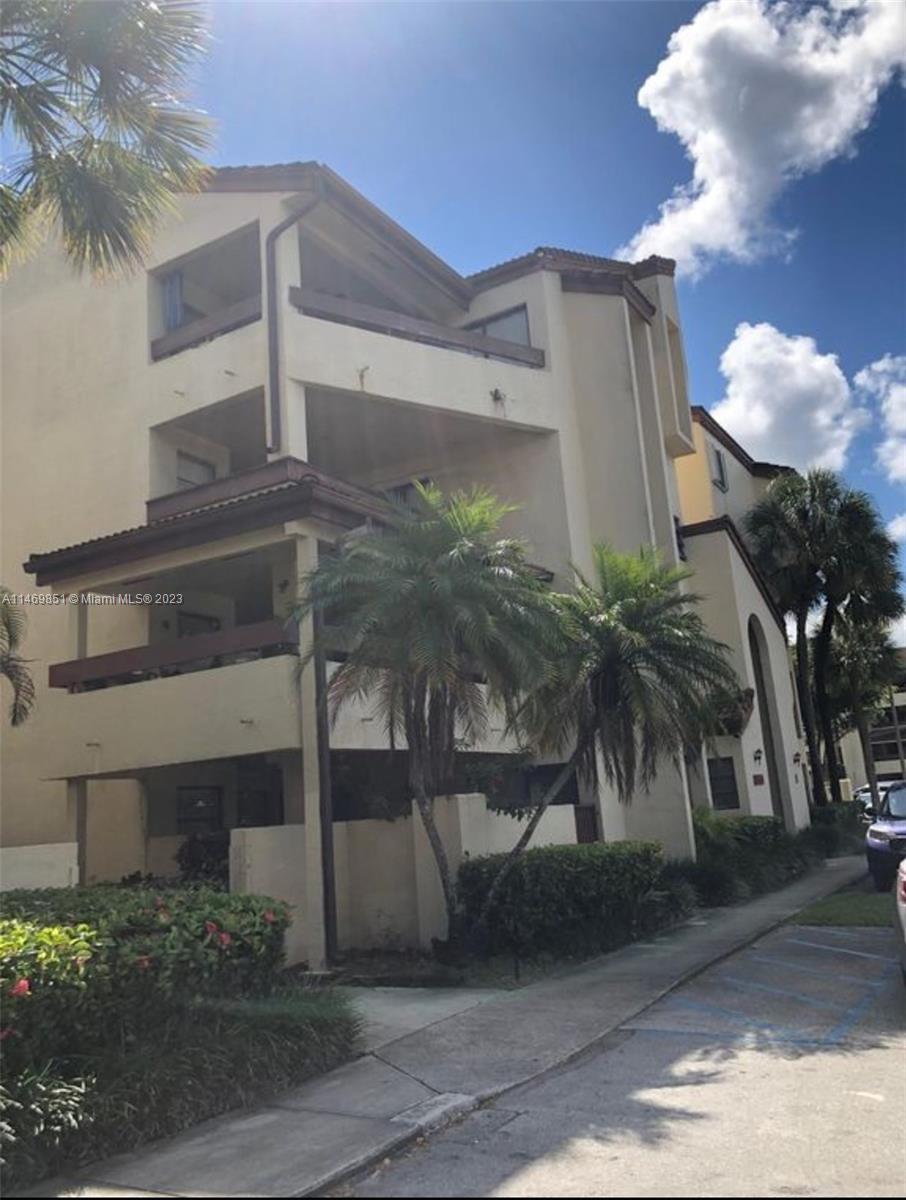 8830 Southwest 123rd Court, Unit I407 Miami, FL 33186 - Photo 1 of 18 a front view of a house with a yard