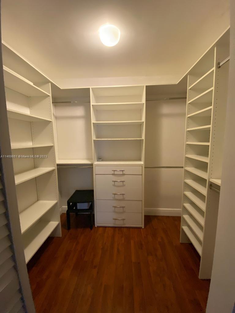 8830 Southwest 123rd Court, Unit I407 Miami, FL 33186 - Photo 16 of 18 a view of walk in closet with empty racks