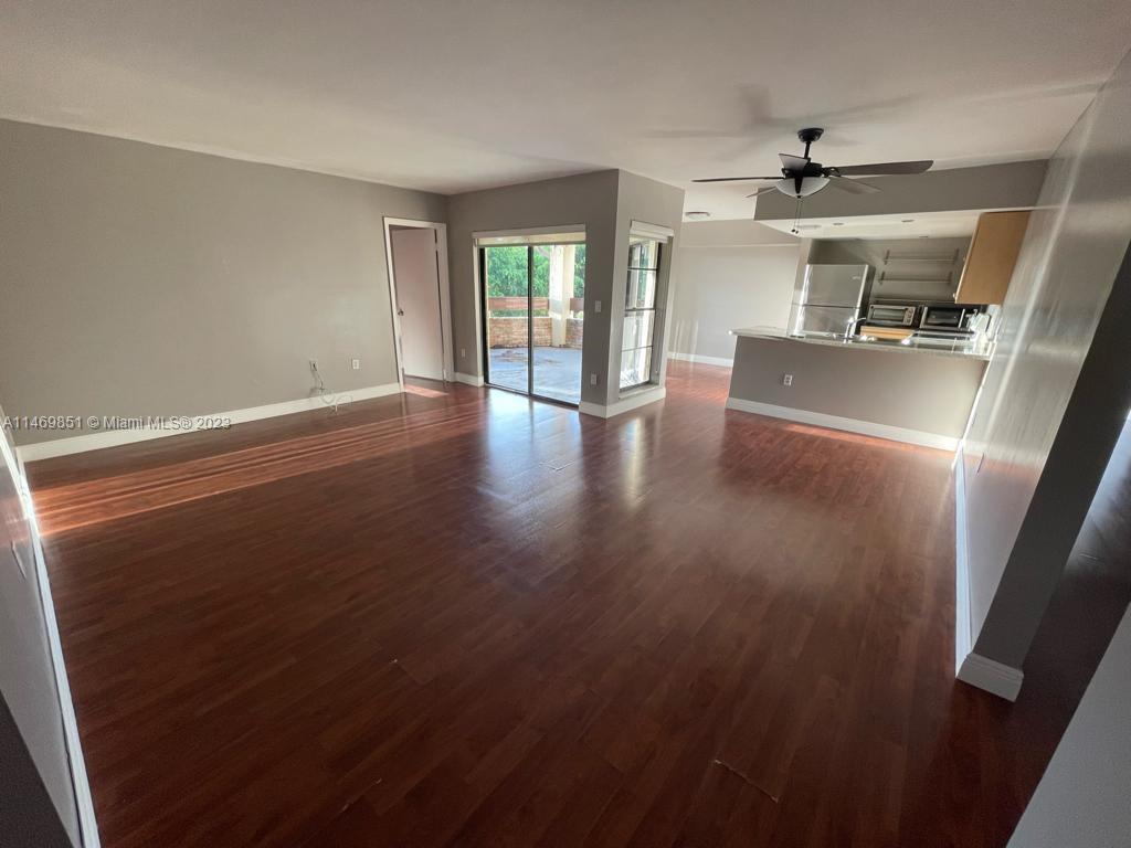 8830 Southwest 123rd Court, Unit I407 Miami, FL 33186 - Photo 4 of 18 an empty room with wooden floor and windows