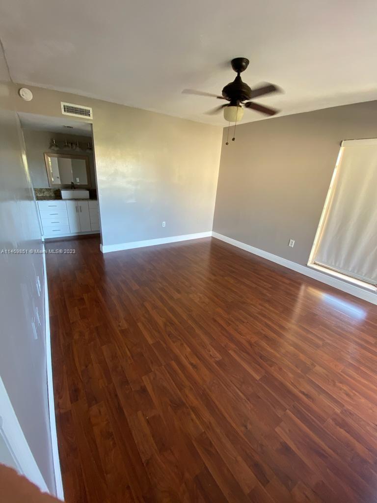 8830 Southwest 123rd Court, Unit I407 Miami, FL 33186 - Photo 9 of 18 wooden floor in an empty room with a window