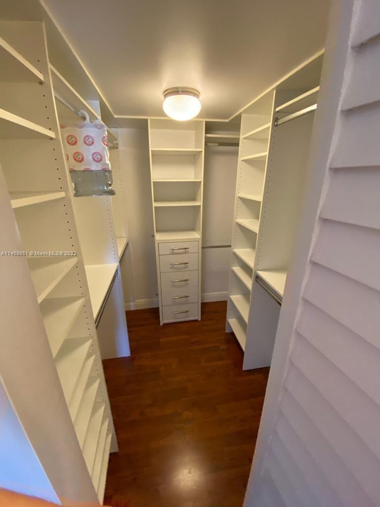 8830 Southwest 123rd Court, Unit I407 Miami, FL 33186 - Photo 10 of 18 a view of walk in closet with empty racks