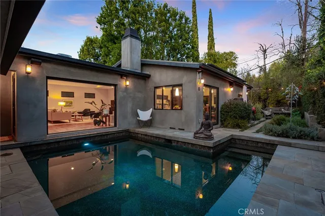 a backyard of a house with yard and outdoor seating