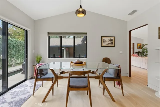 a living room with a couch and a potted plant