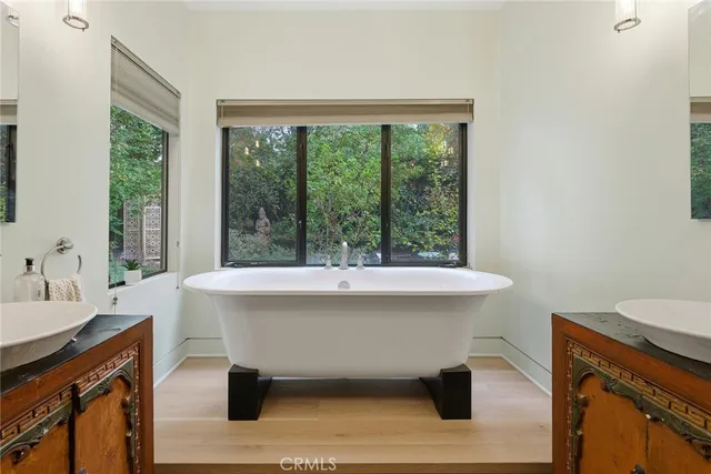 a bedroom with a bed couch and a large window