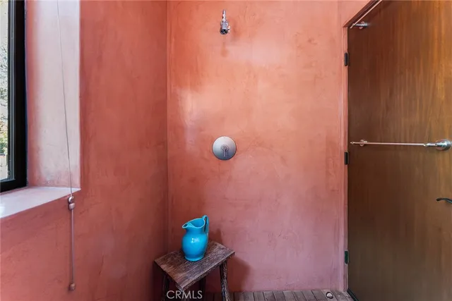 a front view of a house with a garden and swimming pool