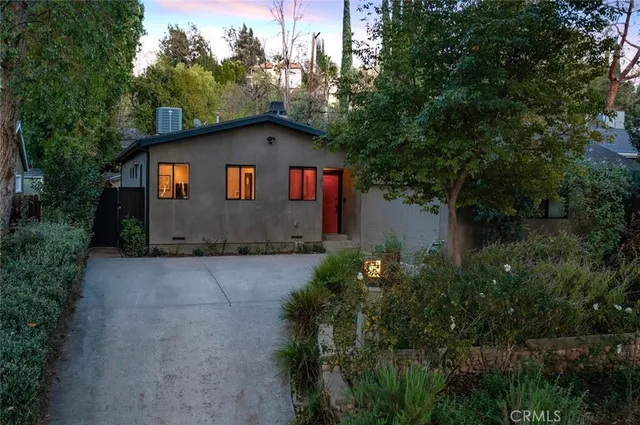 a house with green field in front of it
