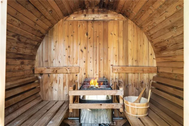 a view of backyard with seating space and trees