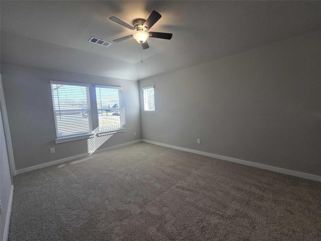 331 East Hull Street Denison, TX 75021 - Photo 16 of 17 en empty room with windows and ceiling fan