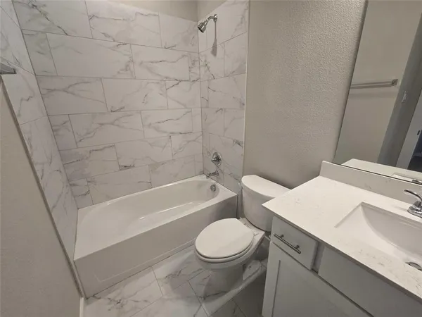a bathroom with a toilet a sink and a bathtub