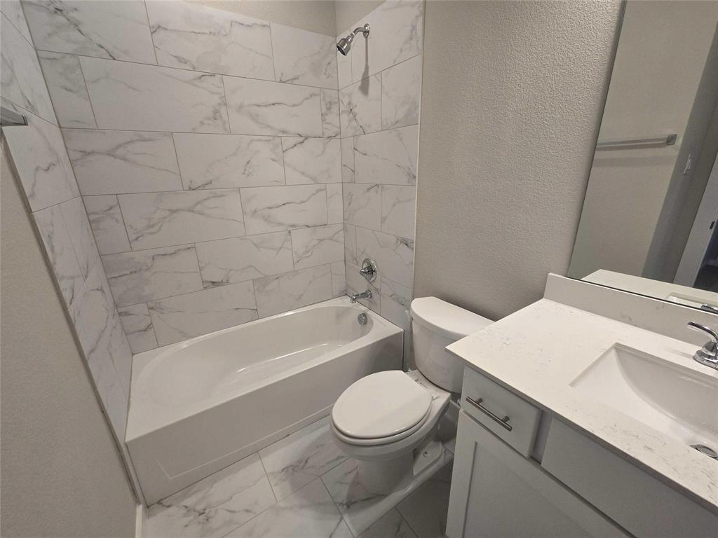 331 East Hull Street Denison, TX 75021 - Photo 17 of 17 a bathroom with a toilet a sink and a bathtub