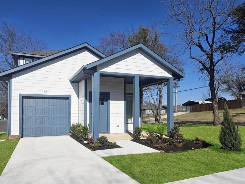 331 East Hull Street Denison, TX 75021 - Photo 2 of 17 a front view of a house with garden