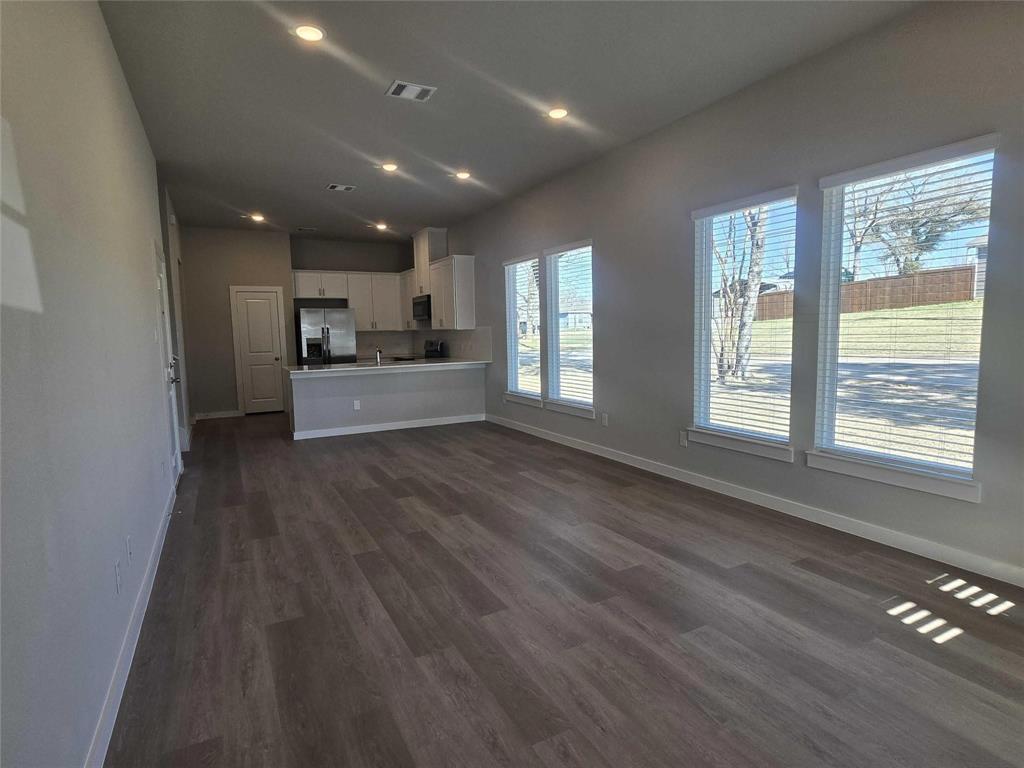 331 East Hull Street Denison, TX 75021 - Photo 6 of 17 a large kitchen with large windows and wooden floor