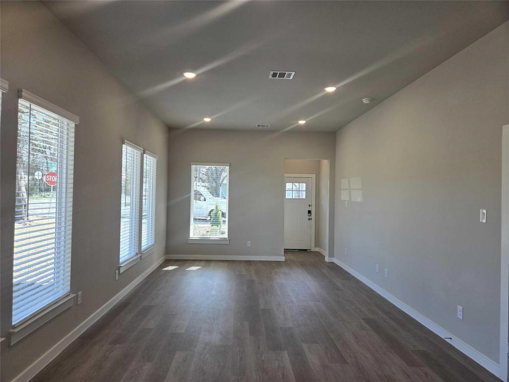331 East Hull Street Denison, TX 75021 - Photo 9 of 17 an empty room with wooden floor and windows