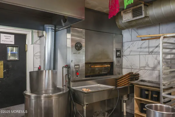 a kitchen with a refrigerator and a stove top oven