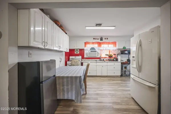 a kitchen with cabinets a sink and appliances