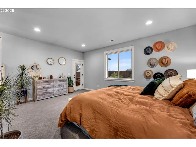 a bedroom with a bed and dresser with mirror