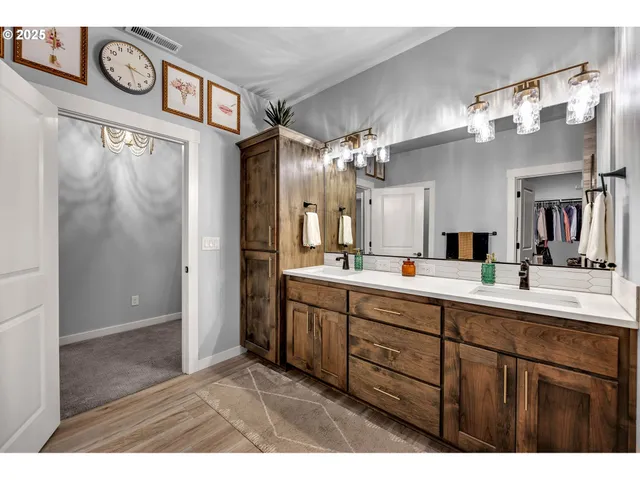 a bathroom with a sink a large mirror and vanity