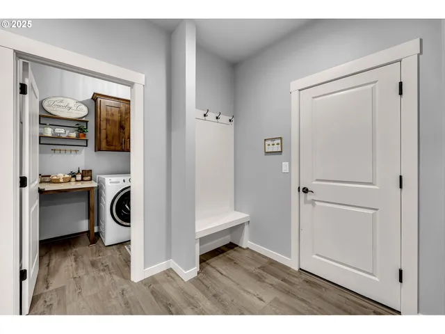 a view of an entryway with wooden floor