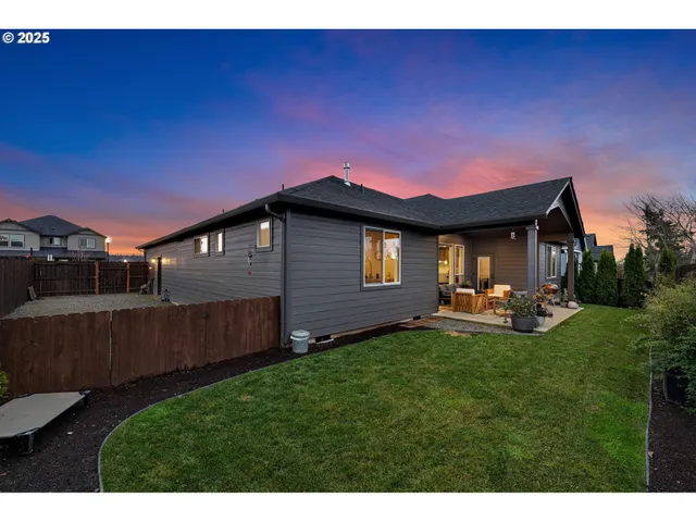 a backyard of a house with table and chairs
