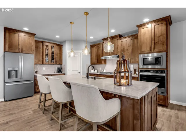 a kitchen with kitchen island a appliances dining table and chairs