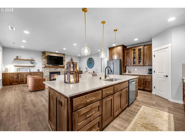 a kitchen with kitchen island a sink appliances and cabinets