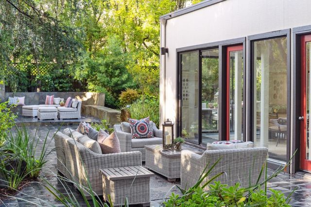 a view of a patio with couches chairs and potted plants