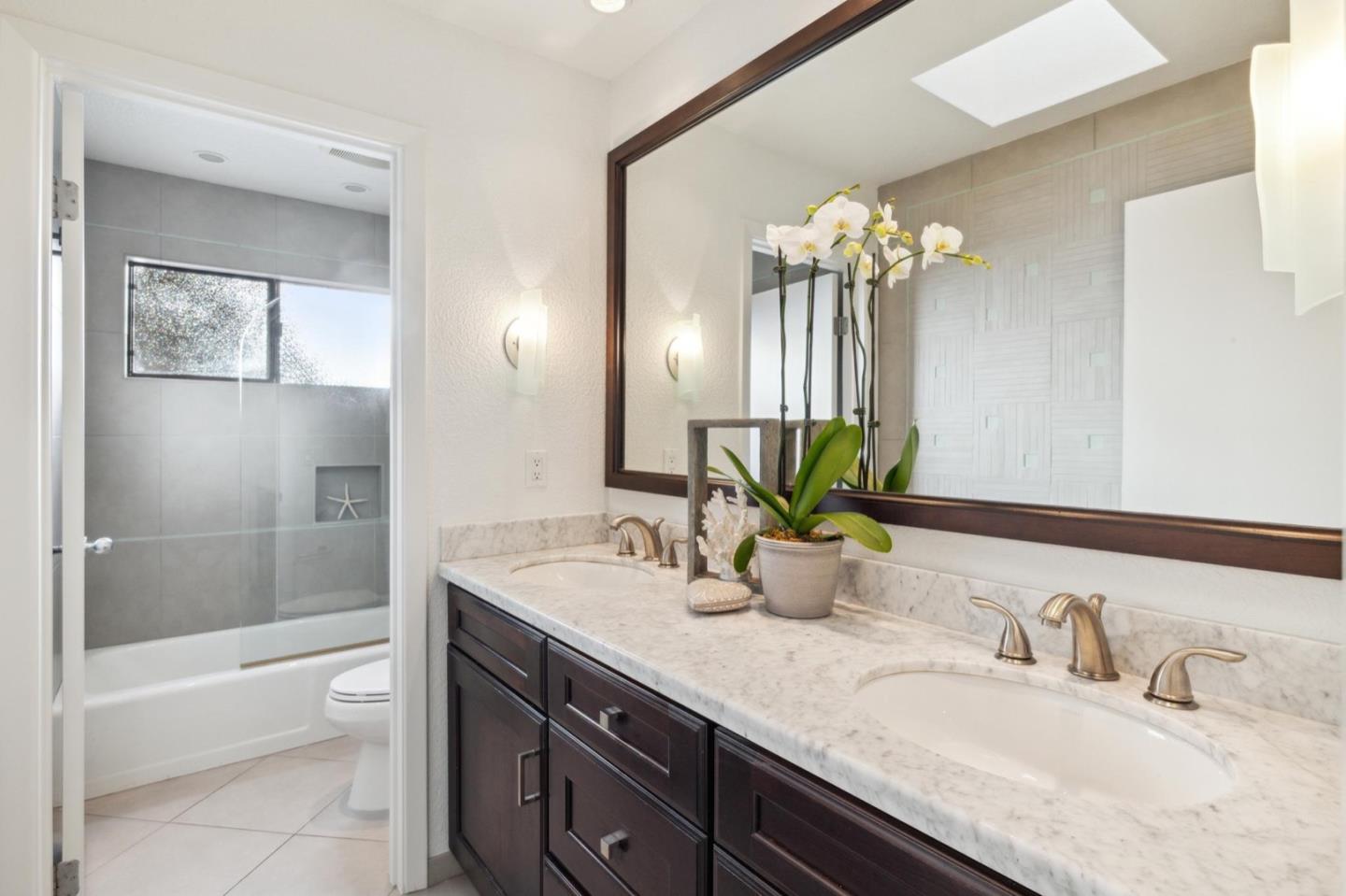 1732 Middlefield Road Palo Alto, CA 94301 - Photo 37 of 42 a bathroom with a granite countertop sink a toilet and a mirror