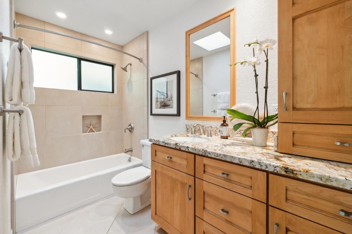 1732 Middlefield Road Palo Alto, CA 94301 - Photo 39 of 42 a bathroom with a granite countertop sink and a large mirror