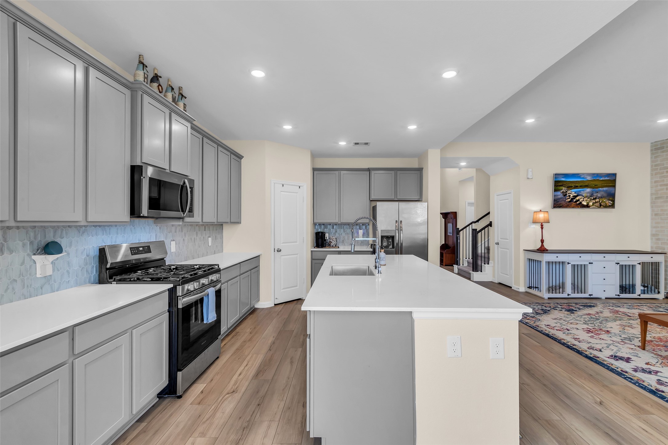 9502 Marble Park Lane Baytown, TX 77521 - Photo 19 of 40 a kitchen with stainless steel appliances granite countertop a sink stove microwave and refrigerator