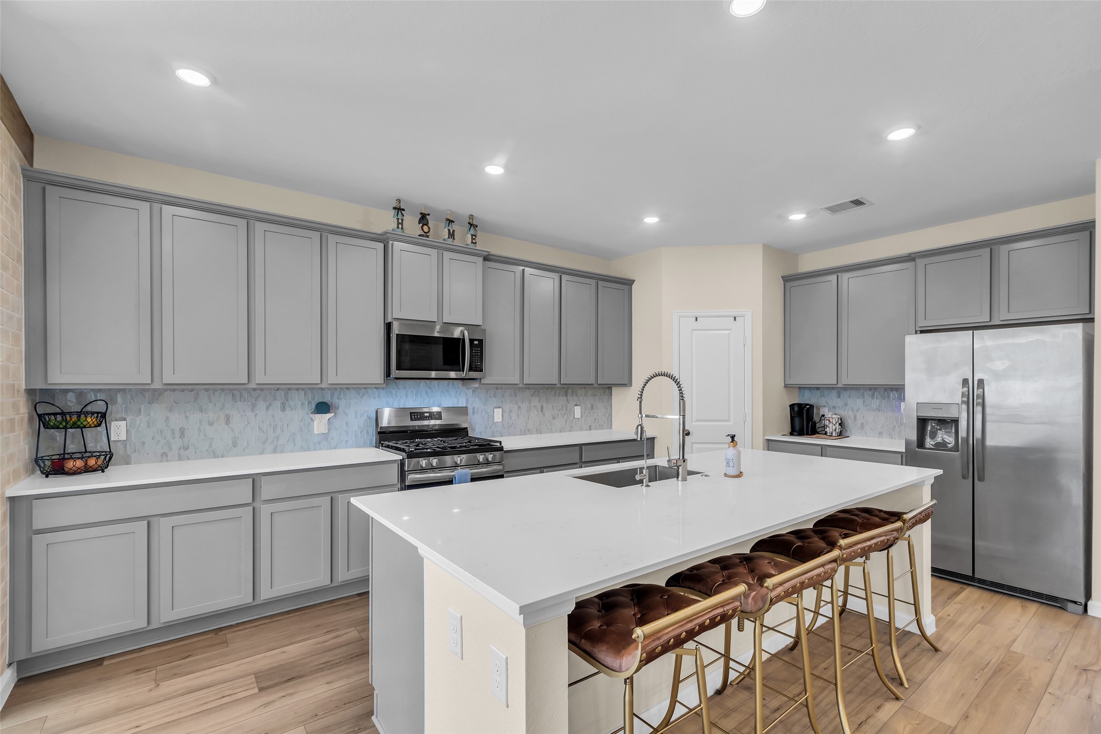 9502 Marble Park Lane Baytown, TX 77521 - Photo 20 of 40 a kitchen with a sink a stove a refrigerator and white cabinets