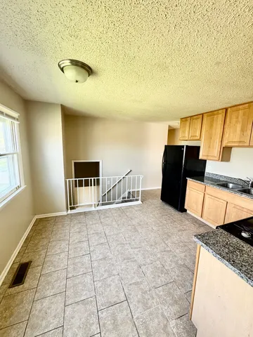 a view of a livingroom with kitchen