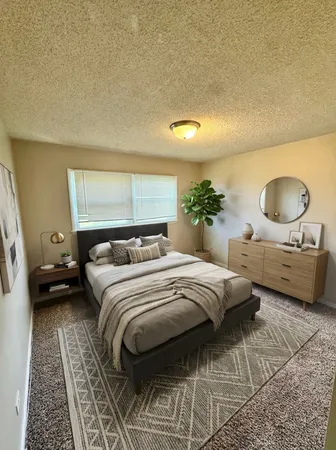 a bedroom with a bed and a couch