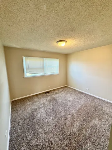 an empty room with a empty space and a window