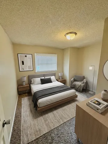 a bedroom with a bed and a couch