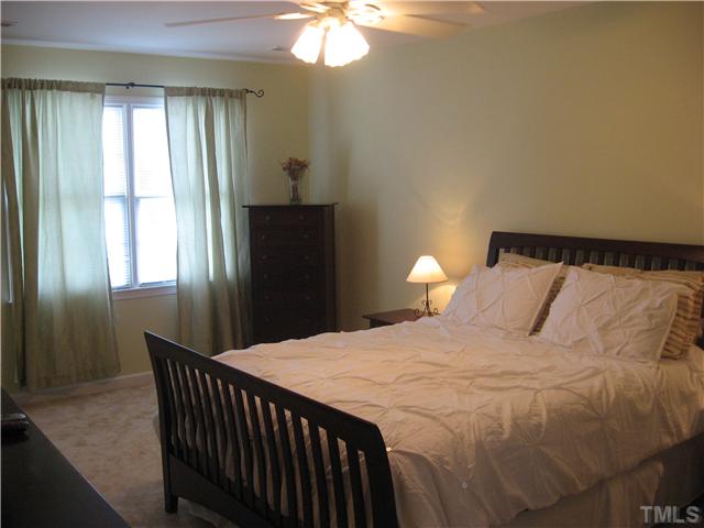 1515 Patterson Grove Road Apex, NC 27502 - Photo 11 of 25 The large master bedroom has his/her closets, ceiling fan, and luxury bath. Brand new carpeting.