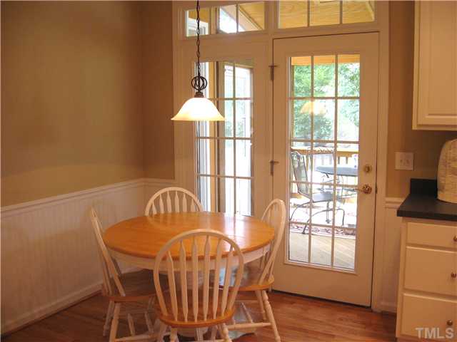 Breakfast area features beadboard, chair rail, updated light fixture, transom windows and leads to the amazing screened porch.