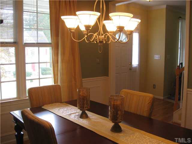 Sidelights and transom window allow natural light into the foyer.  Updated light fixture in the dining room.