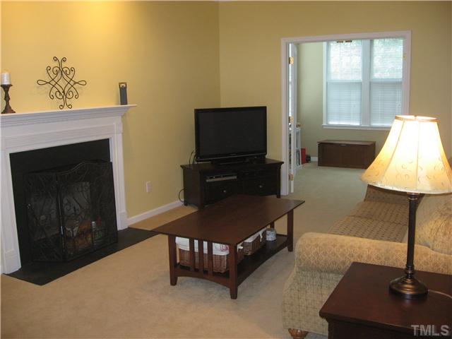 Large family room features a fireplace, recessed lighting, ceiling fan, and has French doors leading to the sunroom.