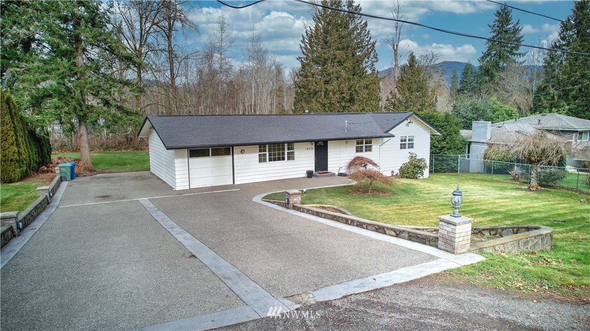 18236 Southeast 135th Street Renton, WA 98059 - Photo 1 of 31 a front view of a house with garden