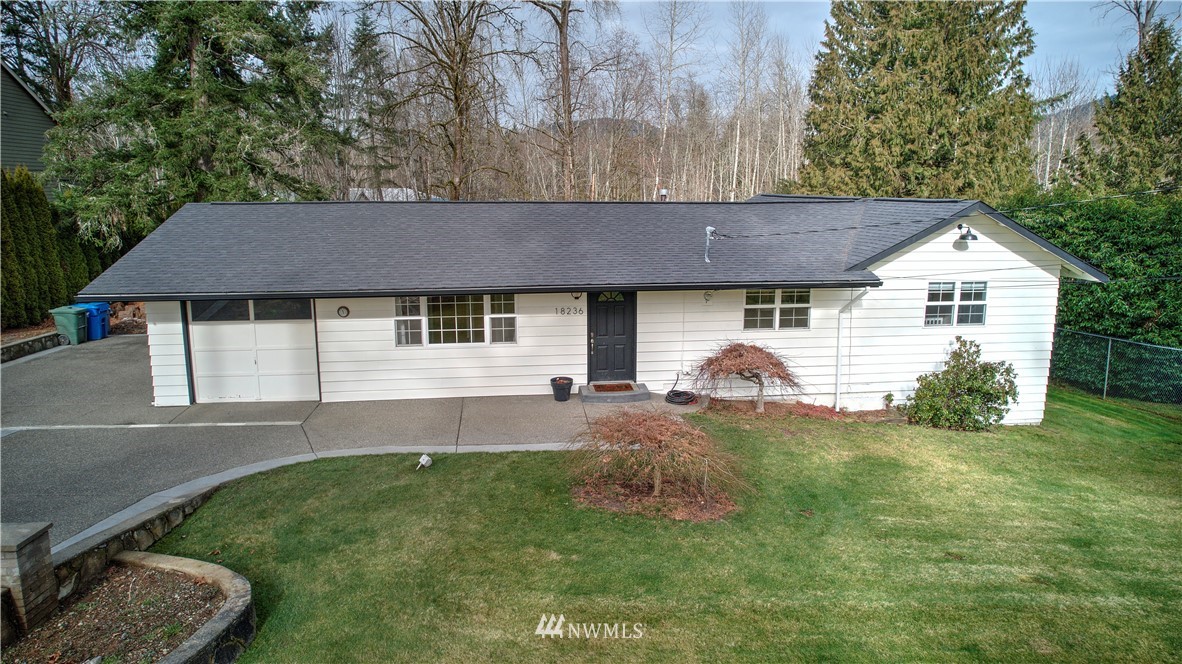 18236 Southeast 135th Street Renton, WA 98059 - Photo 2 of 31 a front view of a house with a garden and yard
