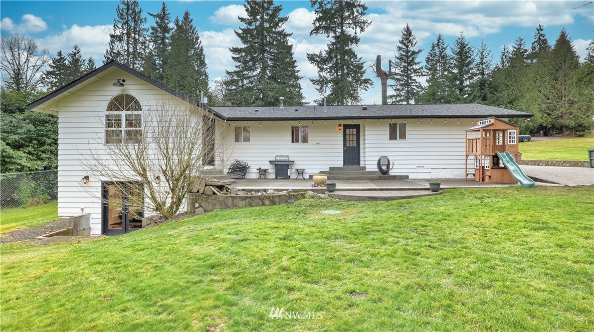 18236 Southeast 135th Street Renton, WA 98059 - Photo 22 of 31 a front view of house with yard and trees in the background