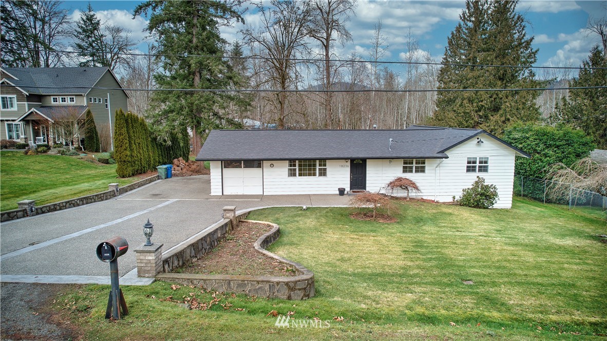 18236 Southeast 135th Street Renton, WA 98059 - Photo 3 of 31 a view of a house with a swimming pool and a yard
