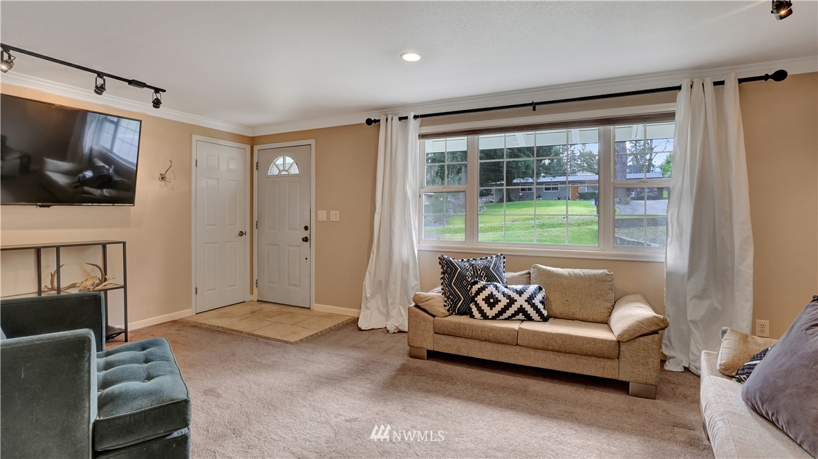 18236 Southeast 135th Street Renton, WA 98059 - Photo 6 of 31 a living room with furniture and a flat screen tv