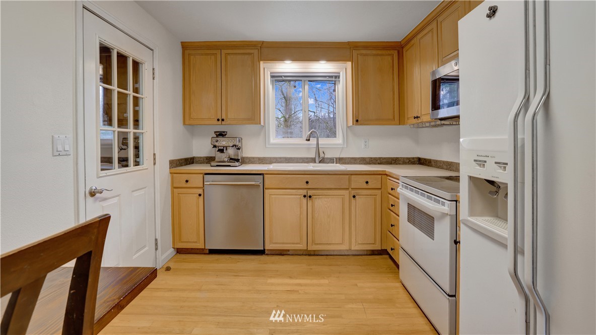 18236 Southeast 135th Street Renton, WA 98059 - Photo 8 of 31 a kitchen with white cabinets and white appliances