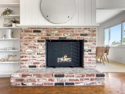a living room with furniture potted plant and a window