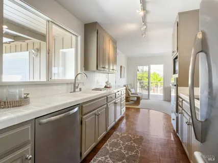 a bedroom with a bed a dresser and next to a window