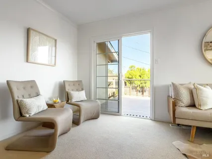a balcony with table and chairs