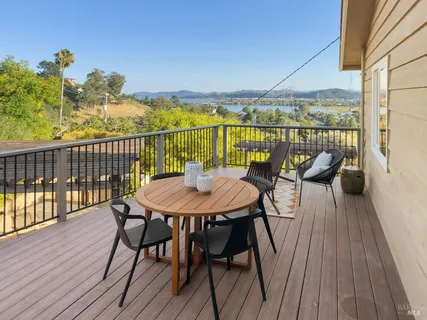a spacious bathroom with a granite countertop toilet a sink a mirror and a window