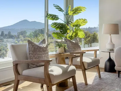 a view of a big house with a big yard and large tree