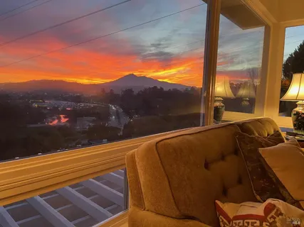 a view of a dining room with furniture and a window